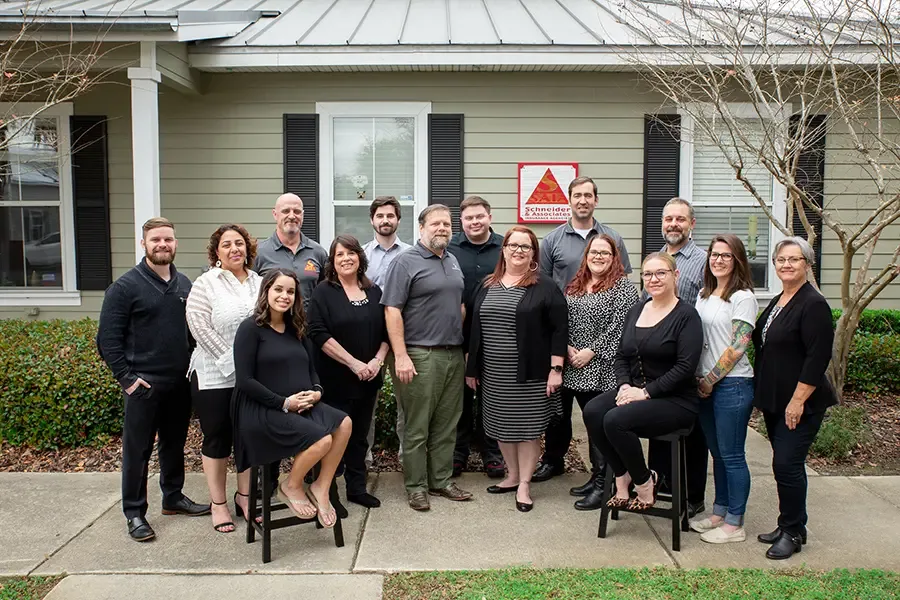 About Our Agency Happy Team of Schneider and Associates Insurance Agencies Posing For a Group Portrait in Front of Office We Are Independent  