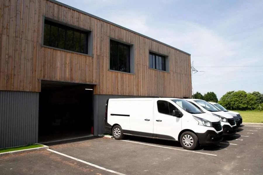 Business Auto Insurance Fleet of Vans Outside of a Loading D Business Auto Insurance Coverage to help protect your business cars, trucks, and other vehicles.