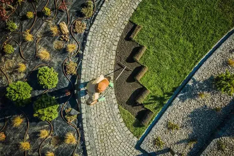 Landscaping Services Insurance Hardworking Man Laying Down Grass Next to Garden Beds in the Late Afternoon 768x512 1 Landscaping Services Insurance  