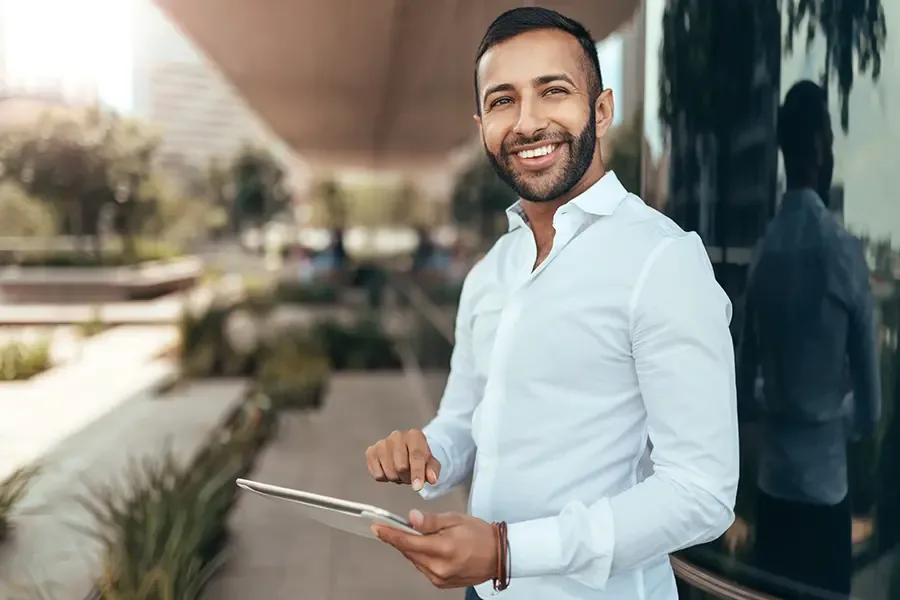 Client Center Portrait of a Young Man Smiling and Holding a Tablet and Looking into Camera Client Center As an independent agency, we are here to help you find the right coverage.